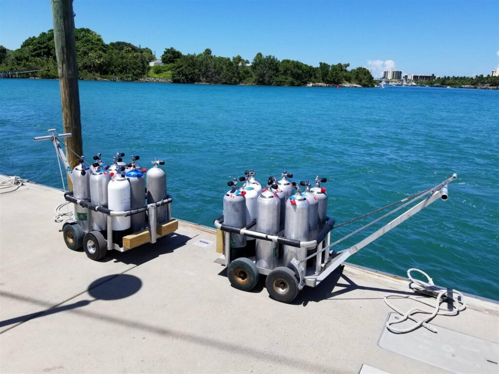The  SCUBA NINER, aluminum scuba tank holder on the pier holding scuba tanks.